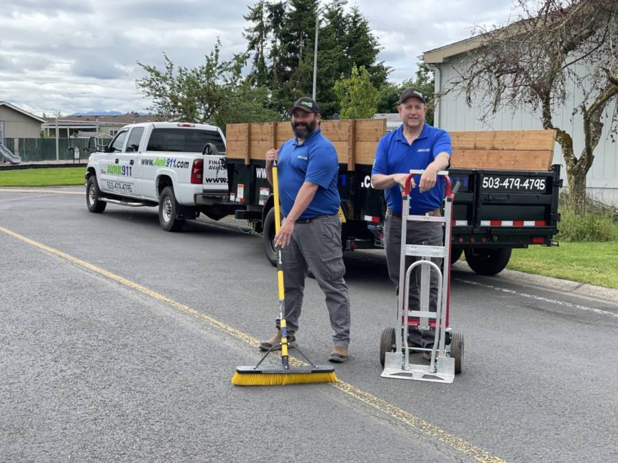 junk removal pros standing with tools